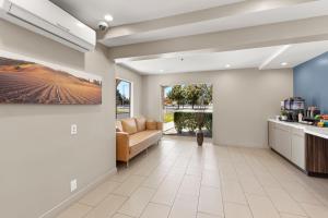 a living room with a couch and a kitchen at Good Nite Inn Camarillo in Camarillo