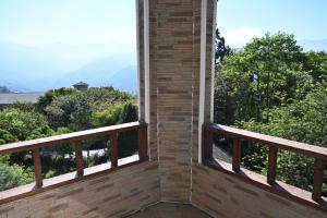 a balcony with a view of trees and mountains at Dreamtown in Ren'ai