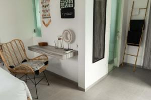 a room with a table and a chair in a room at Villa Kalma Canggu in Canggu