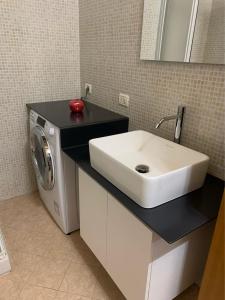 a bathroom with a sink and a washing machine at Stella / Bergamo center in Bergamo