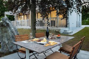 a table with food and glasses of wine on it at Villa Mihaela in Bled