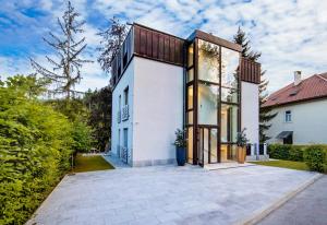 an exterior view of a white house with large windows at Villa Mihaela in Bled