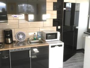 a small kitchen with a sink and a microwave at Snug apartment in Grevesm hlen with terrace in Grevesmühlen