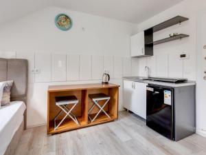 a small kitchen with a counter and a stove at Deluxe apartment in Oberhausen with terrace in Oberhausen