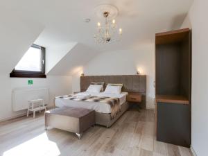a bedroom with a large bed and a chandelier at Deluxe apartment in Oberhausen with terrace in Oberhausen