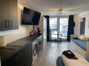 a room with a kitchen with a sink and a stove at Ferienwohnung Beutelsbacherstr. 12 C in Stuttgart
