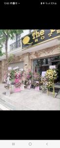 a store with a bunch of flowers in front of it at Hotel The Quin in Hai Phong