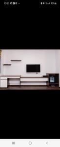 a flat screen tv sitting on top of a table at Hotel The Quin in Hai Phong