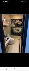 a bathroom with a toilet and a glass door at Hotel The Quin in Hai Phong +17 photos