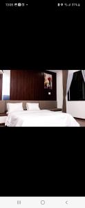 a bedroom with a bed with a laptop on it at Hotel The Quin in Hai Phong