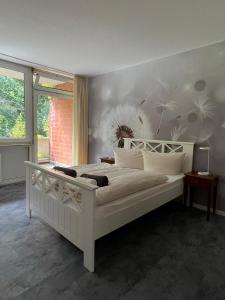 a bedroom with a large white bed in a room at Hotel Scholz in Hitzacker