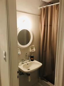 une salle de bain avec un lavabo et un miroir dans l'établissement Akrata v apartment, à Akrata 46 autres photos