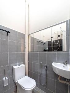 a bathroom with a toilet and a sink at HILMERA Guesthouse in Kuantan