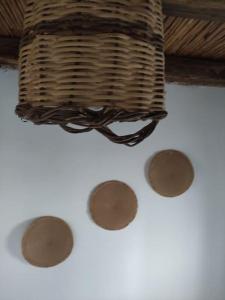 a wicker basket and four brown spots on a table at Villa Elia Ios in Ios Chora