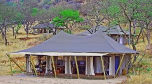 a large tent in the middle of a field at Serengeti Pioneer Camp in Mugumu
