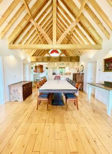 a kitchen and dining room with a table and chairs at House on the Brooks Self catering Holiday let South Downs West Sussex Sleeps 14 in Pulborough
