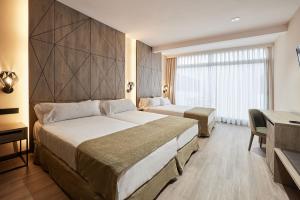 Łóżko lub łóżka w pokoju w obiekcie Hotel Bristol 4 Sup