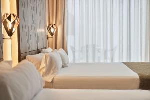 Łóżko lub łóżka w pokoju w obiekcie Hotel Bristol 4 Sup