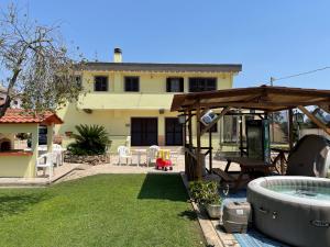 a backyard with a swimming pool and a house at B&b brunos&brunos in Anzio