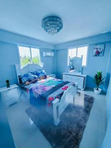 Dormitorio azul con cama y lámpara de araña en a life time memories in a dream vacation home en Mendoza