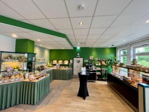 a store with green walls and counters in a store at ACHAT Hotel Monheim am Rhein in Monheim