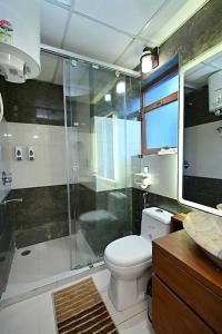 a bathroom with a shower and a toilet and a sink at THE LUXURY STAYS BY GLAMBIRDS - HOME STAY in Solan