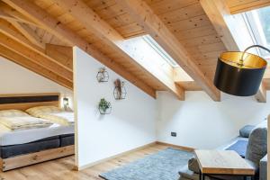 a bedroom with a bed and a vaulted ceiling at Apart Dolomites in Castello di Fiemme