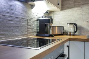 une cuisine avec une cafetière sur le comptoir dans l'établissement Apart Dolomites, à Castello-Molina di Fiemme