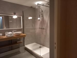 a bathroom with a glass shower with a sink at Hotel Restaurant de la Poste in Saint-Just-en-Chevalet +98 photos