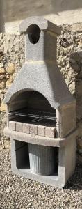 a stone oven sitting next to a stone wall at Fattoria della Sabatina in La Sabatina