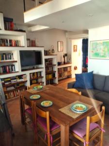 a living room with a wooden table and chairs at Casa di Grazia in Forio d'Ischia +2 photos