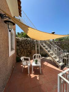 a patio with a hammock and two chairs and a table at Casa Impagliazzo in Ischia