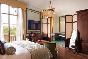 a bedroom with a bed and a room with a desk at Gleneagles Townhouse in Edinburgh