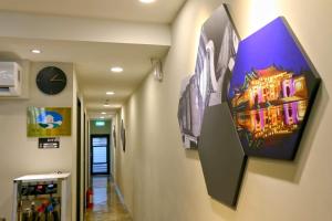 a hallway with a painting on the wall at Lukang Barn Inn in Lugang +22 photos