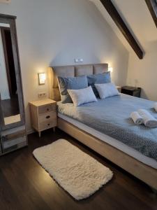 a bedroom with a bed with a mirror and a rug at Apartments and Rooms Jerkovic in Korenica