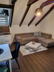 a living room with a couch and a table at Apartments and Rooms Jerkovic in Korenica