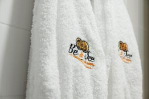 a white towel with two chickens on it at Be&See in River in Ovar