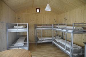 a room with three bunk beds in a cabin at Gröna Uddens Camping in Mariehamn
