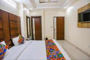 a bedroom with a bed and a tv on the wall at FabHotel Winter Line Inn in Mussoorie