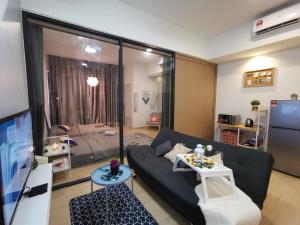 a living room with a couch and a tv at DS19 Dsara tv 5 pax tv mrt next segi college in Sungai Buluh