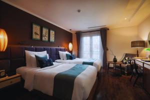 Ένα ή περισσότερα κρεβάτια σε δωμάτιο στο Hotel Emerald Waters Classy