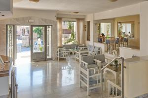 a lobby with chairs and tables and a restaurant at Apollon Hotel Apartments in Platanes