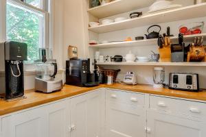 a kitchen with a counter with appliances on it at Four Bedroom Rosedale Home in Toronto
