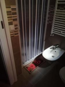 a bathroom with a sink and a shower at Berenice Suite in Taranto