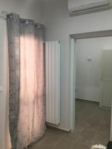 a room with a shower curtain on a wall at Berenice Suite in Taranto