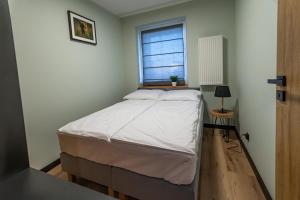 Posteľ alebo postele v izbe v ubytovaní Bison Apartamenty