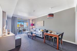 Ruang duduk di 'Esplanade Ease' A Resort Balcony Pad with Pool