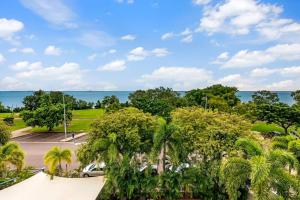 - une vue sur un parking avec des palmiers et l'océan dans l'établissement Oceanview Corner - Resort-like Living with Pool, à Darwin
