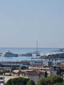 a view of a city with boats in the water at LUXURY APPARTEMENT Vue MER PANORAMIQUE in Antibes