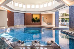 a swimming pool in a house with a ceiling at Grand Hotel Terme & Spa in Montegrotto Terme